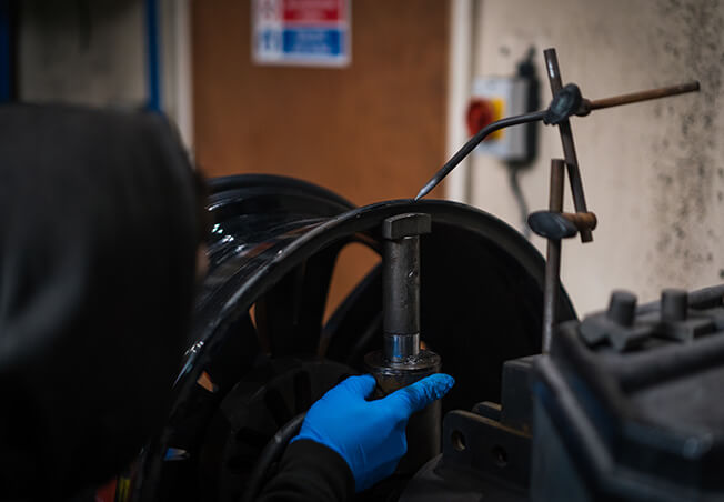 Buckled alloy wheel being straightened on Rolling Rims alloy wheel straightener